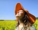 Woman wearing pamela breathing fresh air standing in a field a sunny day