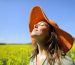 Woman wearing pamela breathing fresh air standing in a field a sunny day