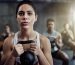 Shot of a fit young woman working out with a kettle bell at the gym